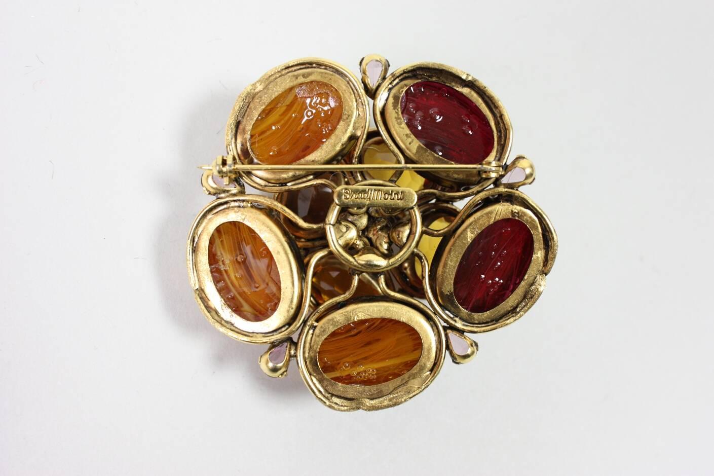 Gorgeous flower brooch from Iradj Moini is in the shape of a three-dimensional flower.  Gold-toned hardware.

Measurements-
2 1/2" Diameter
1 1/4" Tall