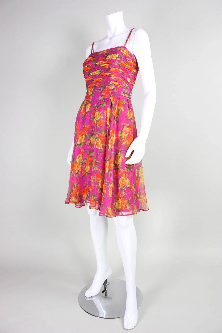 Vintage dress from Valentino dates to the 1990's and is made of a floral-printed silk chiffon that is ruched throughout.  Overskirt is gathered all along fitted waistband with an opening at the center front.  Squared neckline.  Gold-toned rhinestone