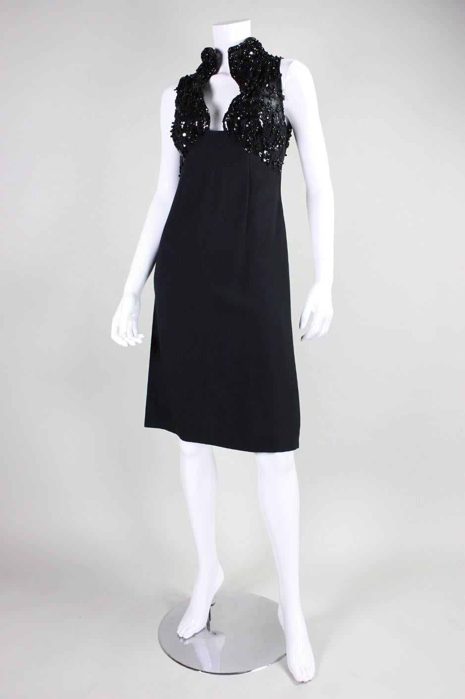 Vintage little black dress dates to the 1960's and is made of a mixture of lace and crepe.  Beaded bust has a deep v-neck and opening at back.  Center back zipper.  Unlined.  Unfortunately the label is no longer present.  The original owner