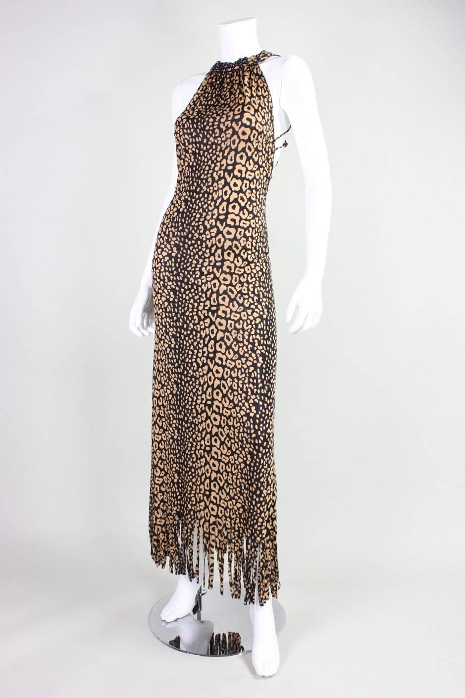 Fabulous and iconic vintage gown and shawl from Loris Azzaro dates to the mid-1970's and features a tan & black leopard print.  Beaded lattice open back. Fringed hem on shawl and gown.  Both pieces are unlined.  Hook and eye closures at side neck. 