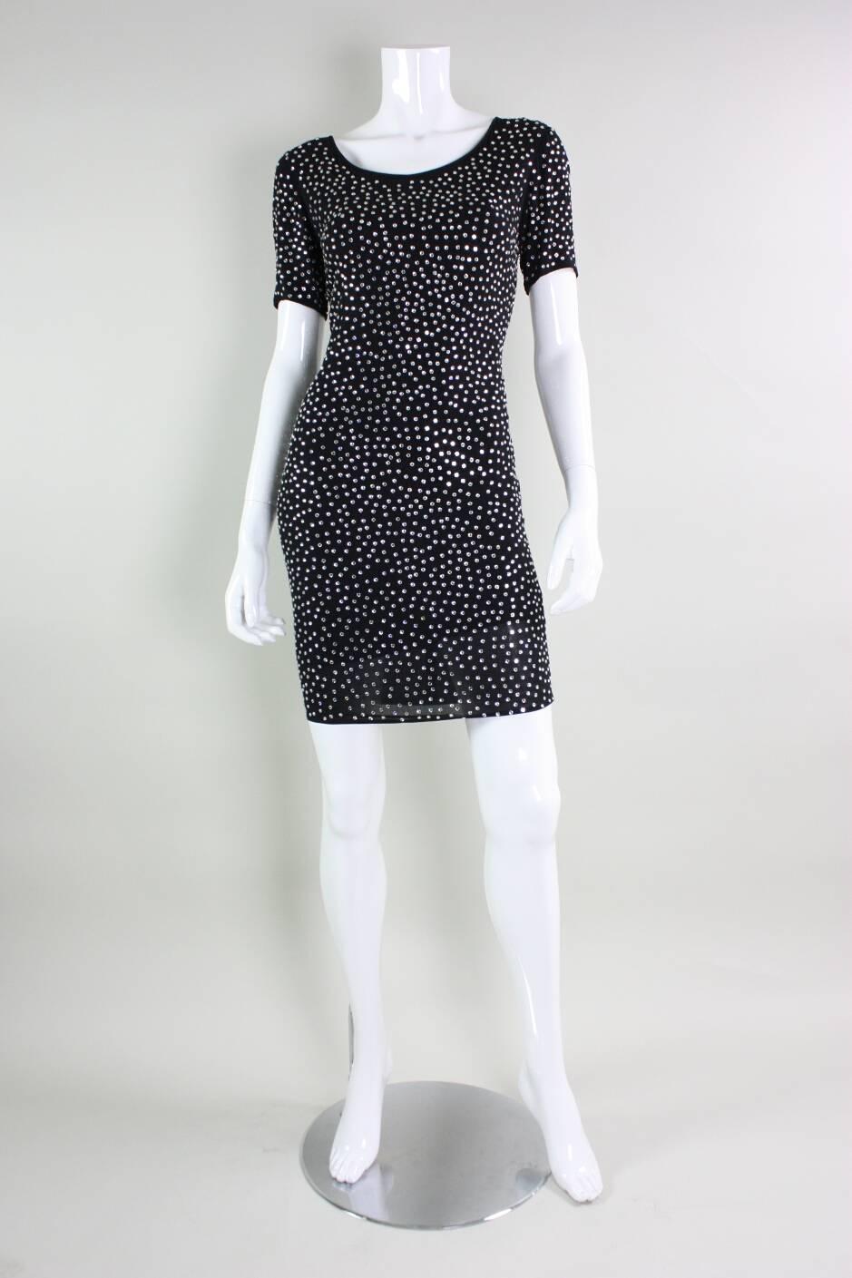 Cocktail dress from Pamela Dennis is made of black matte jersey that is studded with clear prong-set rhinestones.  Short sleeves.  Round neck.  Center back zipper.  Fully lined.

Condition Excellent with a few missing rhinestones.

