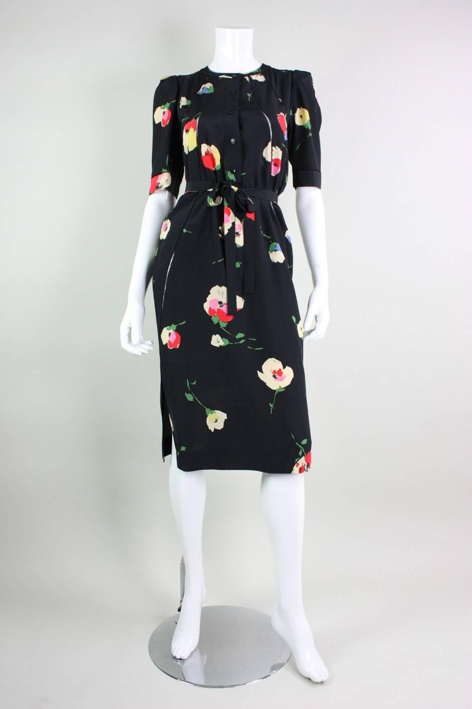 Vintage dress from Chloe dates to the 1970's and gives nod to the styles of the 1940's.  It is made of a textured black silk fabric with a multicolor silk floral print.    Interesting seaming detail leaves skin exposed underneath.  Unlined.  Center