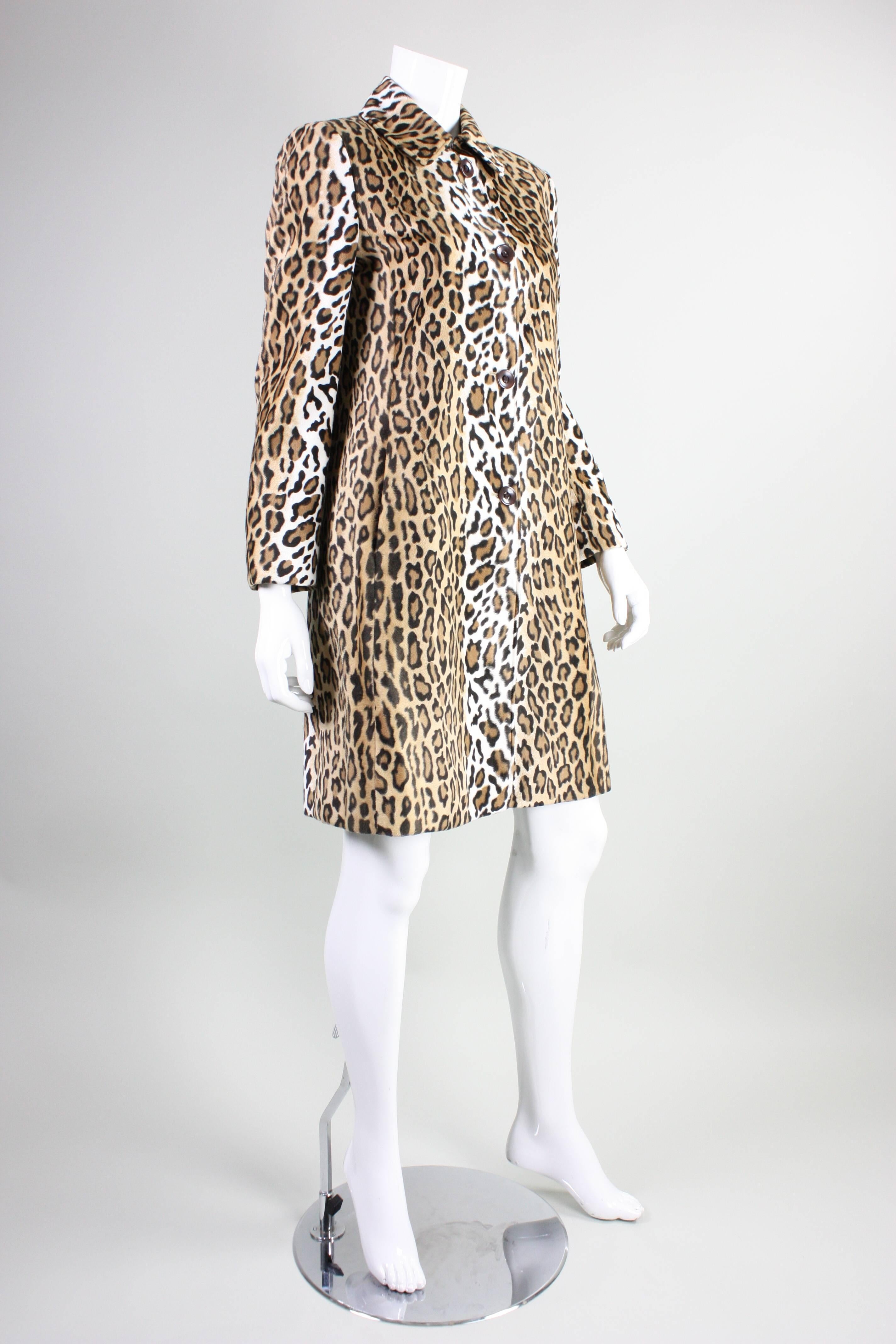 Vintage Moschino Faux Leopard coat dates to the 1990's and is made of a poly-rayon blend.  Single breasted with turn down collar and four center front button closures.  Heart cutouts in buttons.  18 1/2