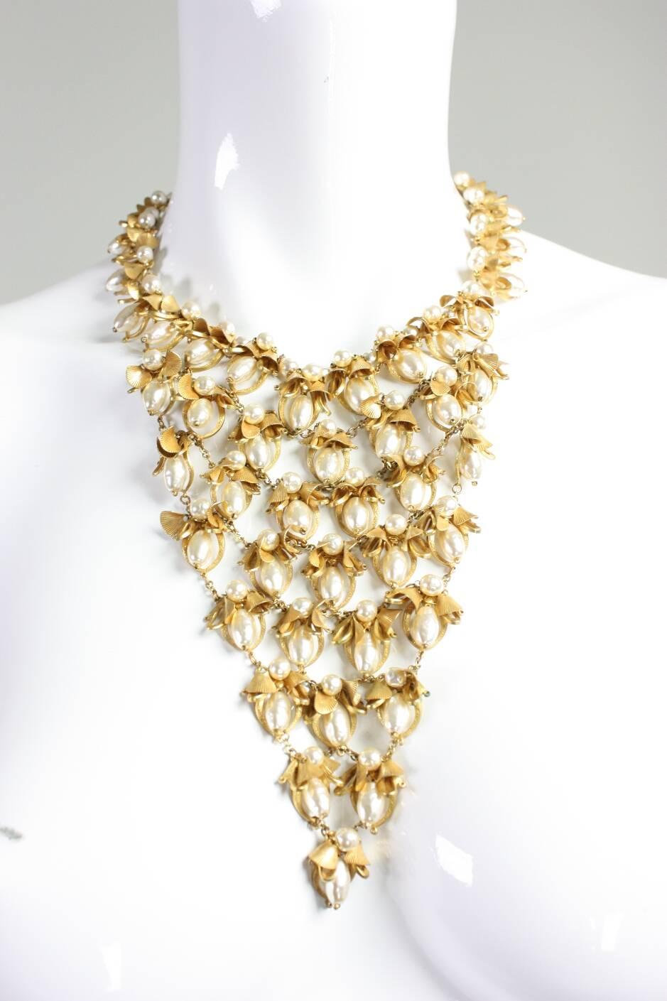 Vintage necklace from Miriam Haskell likely dates from the 1950's to the 1960's and is made of gold-toned metal with faux fresh water pearls.  Signature filigree round box clasp.

Measurements-

Center front: 6 3/4"
Circumference: 17"