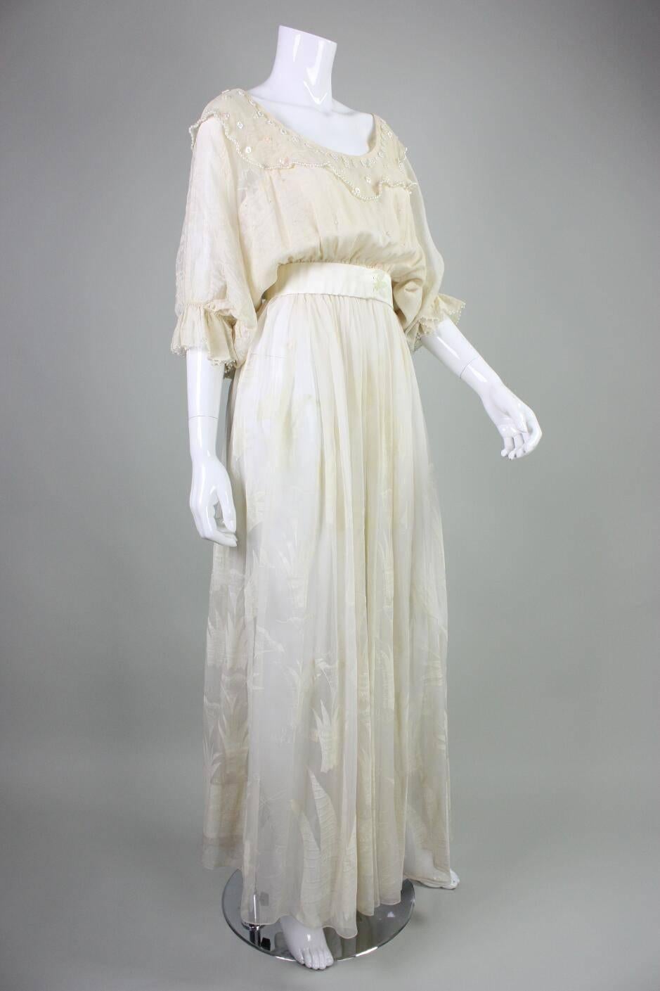 Vintage gown from Zandra Rhodes is made of ivory silk chiffon with her iconic 