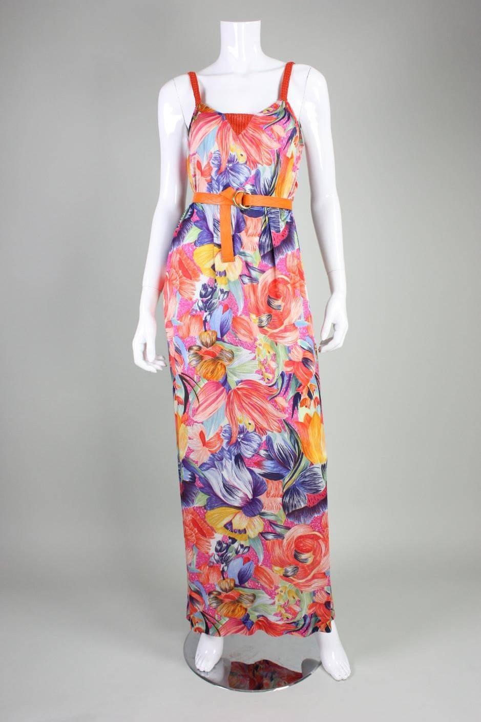 Vintage gown from Missoni dates to the 1970's and retailed at Apropos boutique.  It is made of a soft silk jersey with an active floral print in bold colors.  Orange knit straps and center front insert.  Center back slit at hem.  Unlined. No