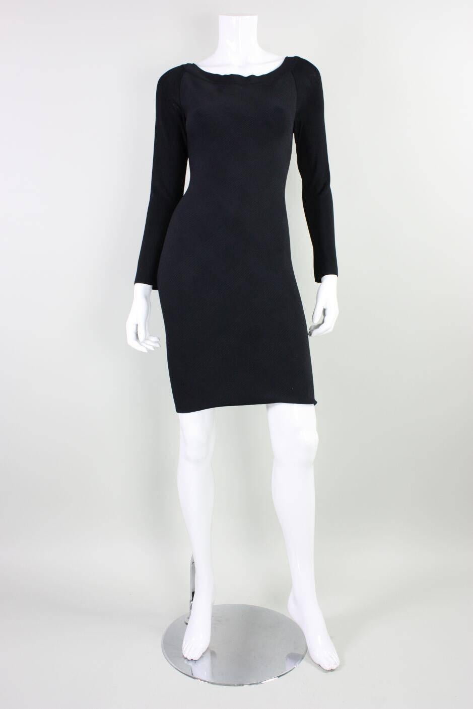 Vintage dress from Herve Leger dates to the 1990's and is made of a body-hugging houndstooth fabric front with plain black sleeves and back.  Boat neck front with v-neck back.  Center back zipper.  Unlined.

Labeled a FR 1, US