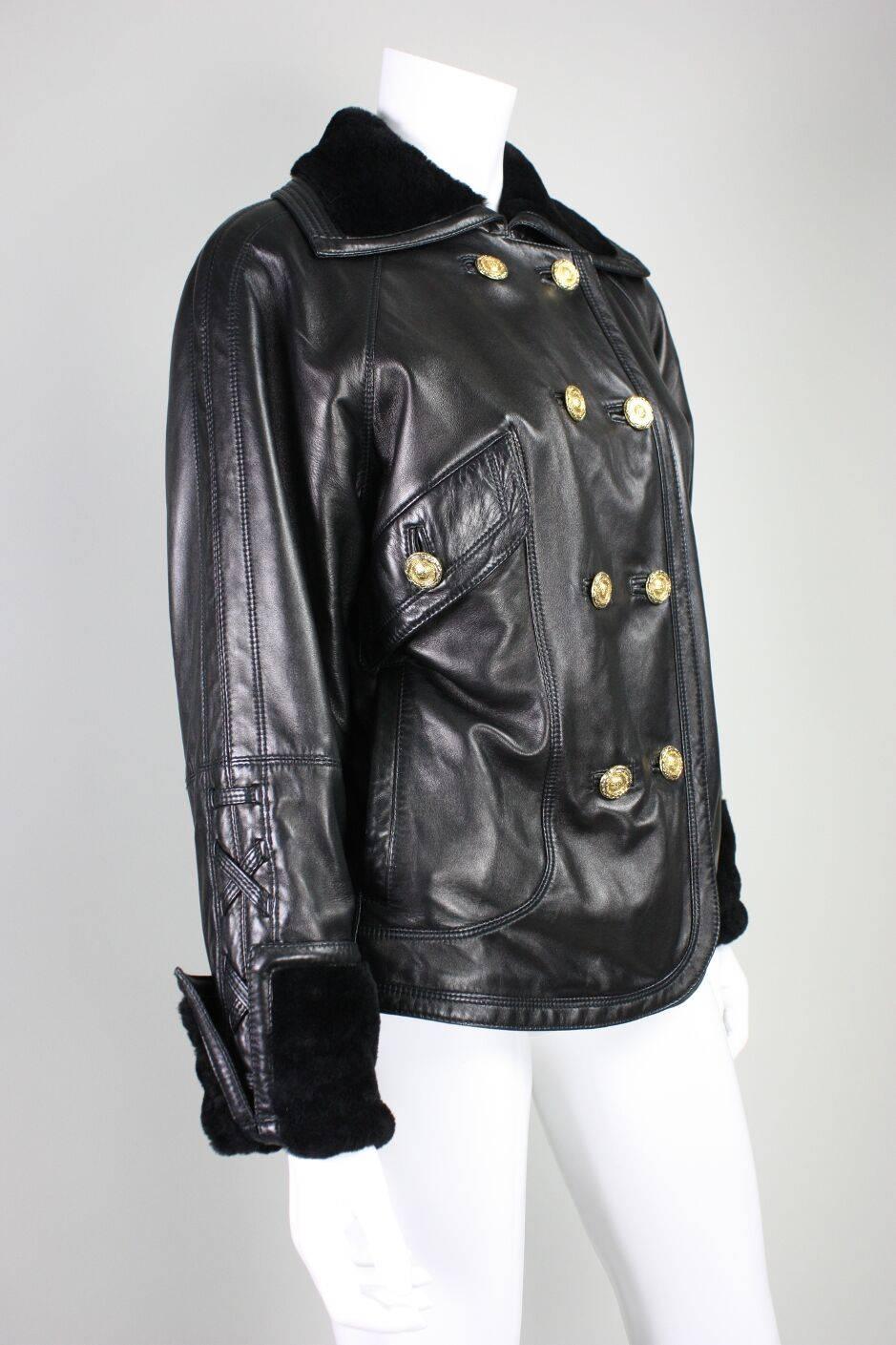 Vintage leather jacket from Gianni Versace dates to the 1990's and is made of buttery soft black leather with black shearling collar and cuffs.  Jacket is double-breasted and features three angled flap pockets and one side-seam pocket and gold-toned