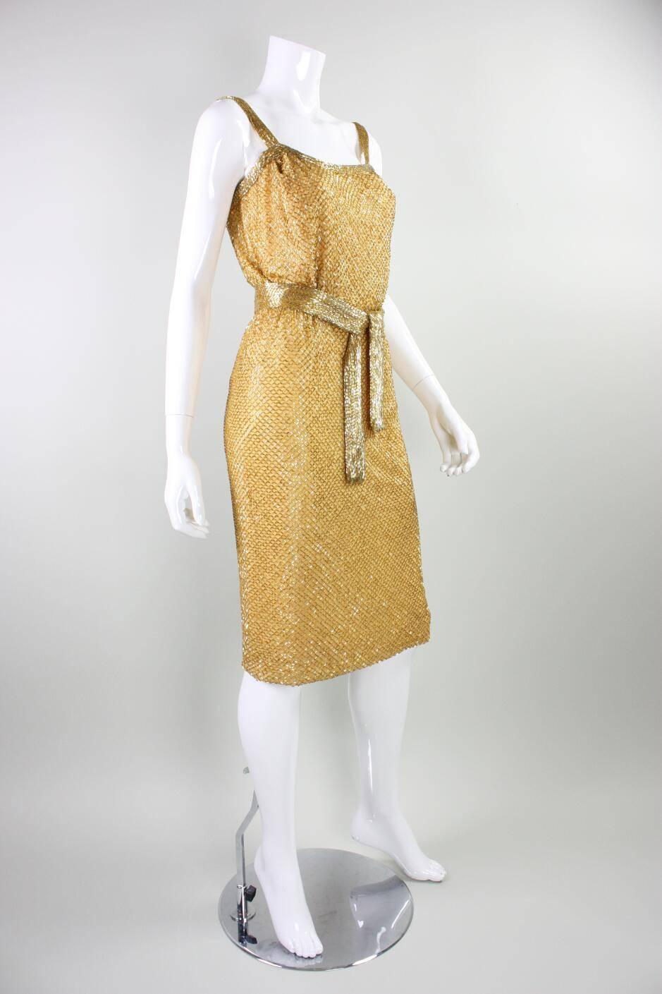 Vintage dress from Ceil Chapman dates to the 1950's and is made of marigold chiffon with all-over gold bugle beading.  Fitted throughout.  Lined.  Center back zipper.  Detached beaded belt.

Measurements-

Bust: 34