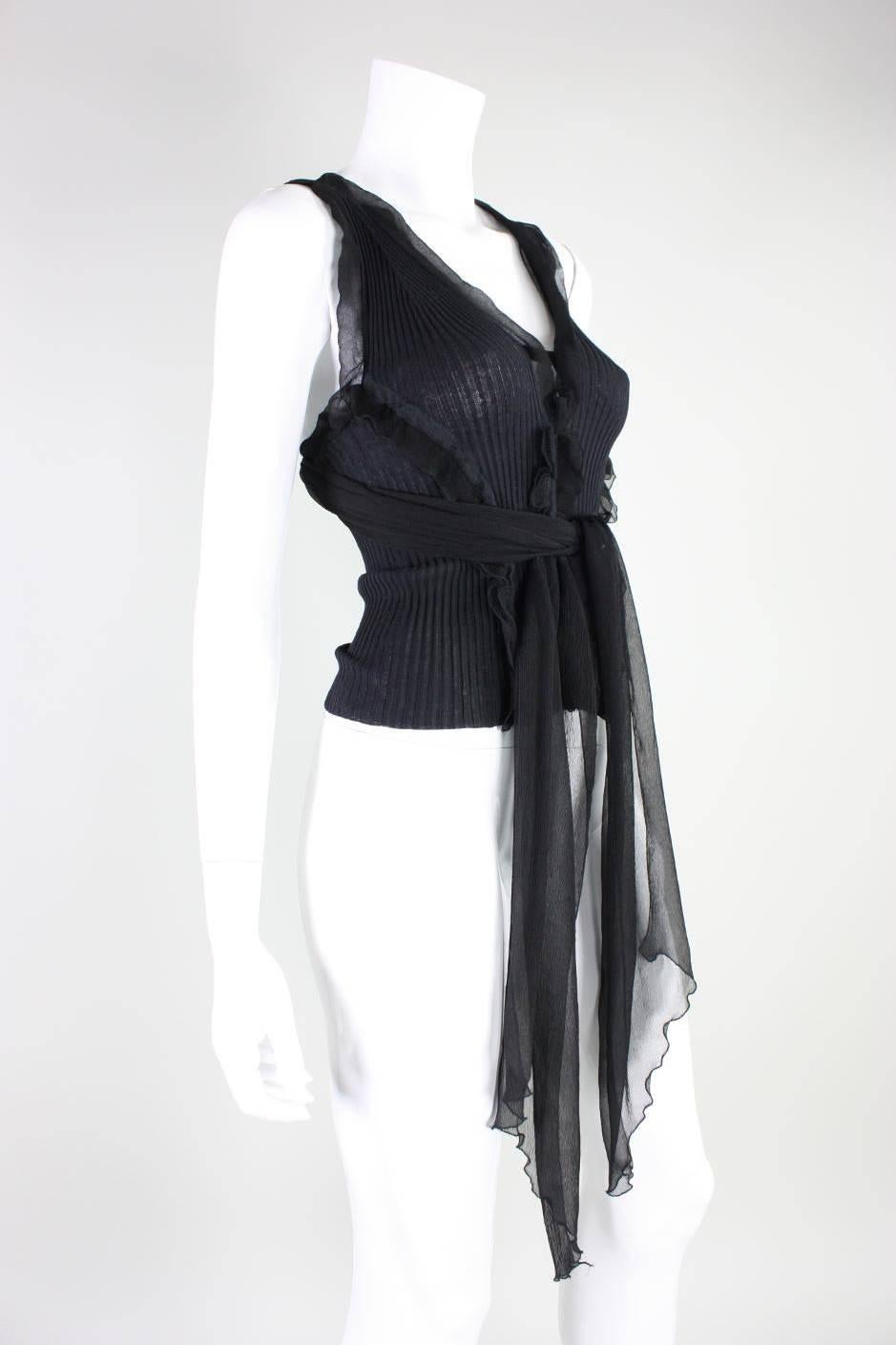 Vintage sweater vest from Jean-Paul Gaultier dates to the 1990's and is made of black ribbed wool knit with black silk chiffon detailing and tie.  Unlined.  No closures.  Never worn.

Labeled size Small.
