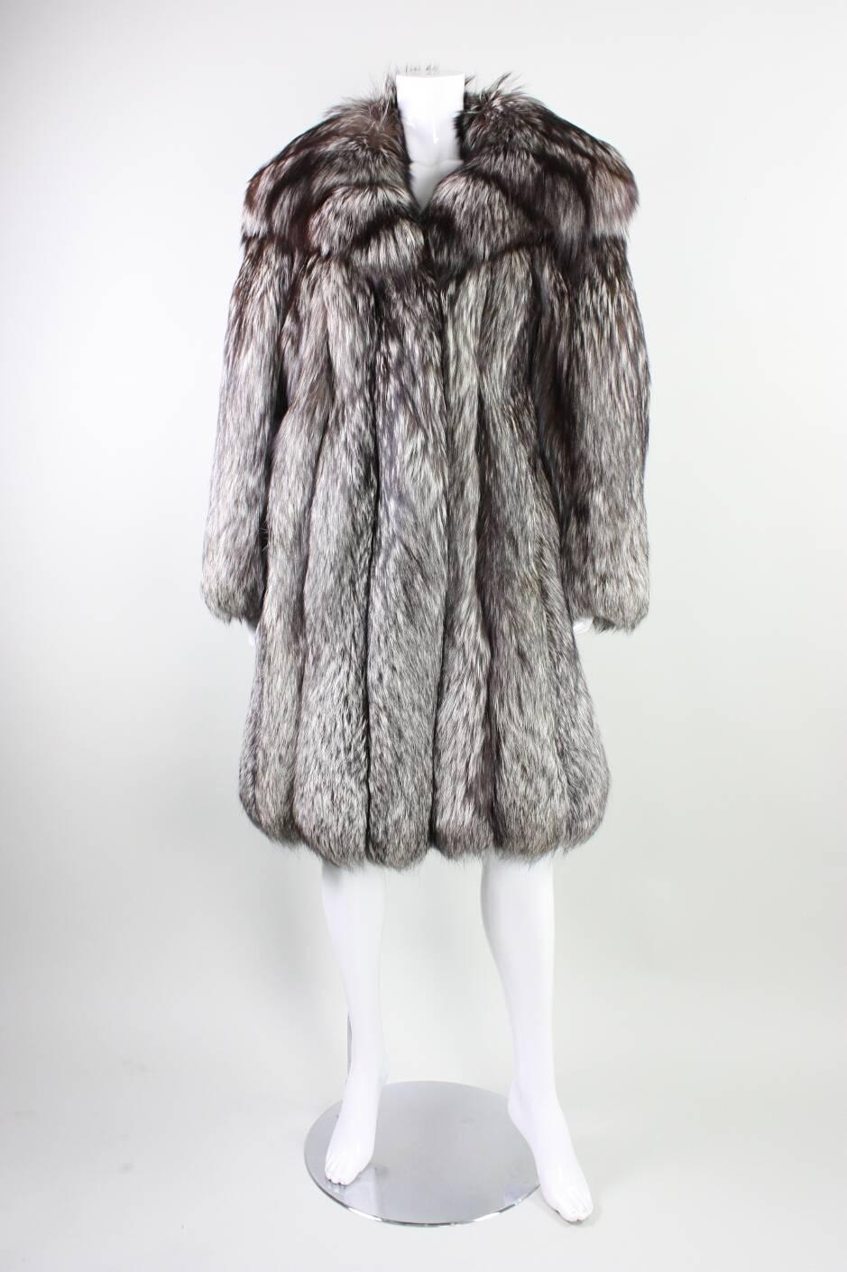 Vintage silver fox fur likely dates to the 1980's through 1990's and was manufactured by NH Rosenthal Furs in Chicago.  Lined with black satin.  Hip pockets with velvet lining.  

Condition: Excellent condition.  Stored in climate controlled