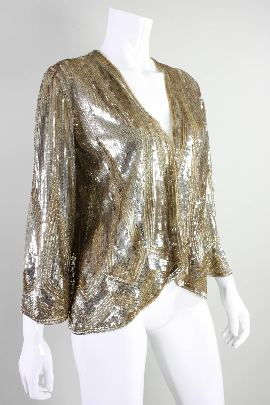 Vintage jacket is made of beige netting that is fully covered in gold celluloid sequins that are arranged in a geometric Art Deco pattern. Tag identifies the piece as being 