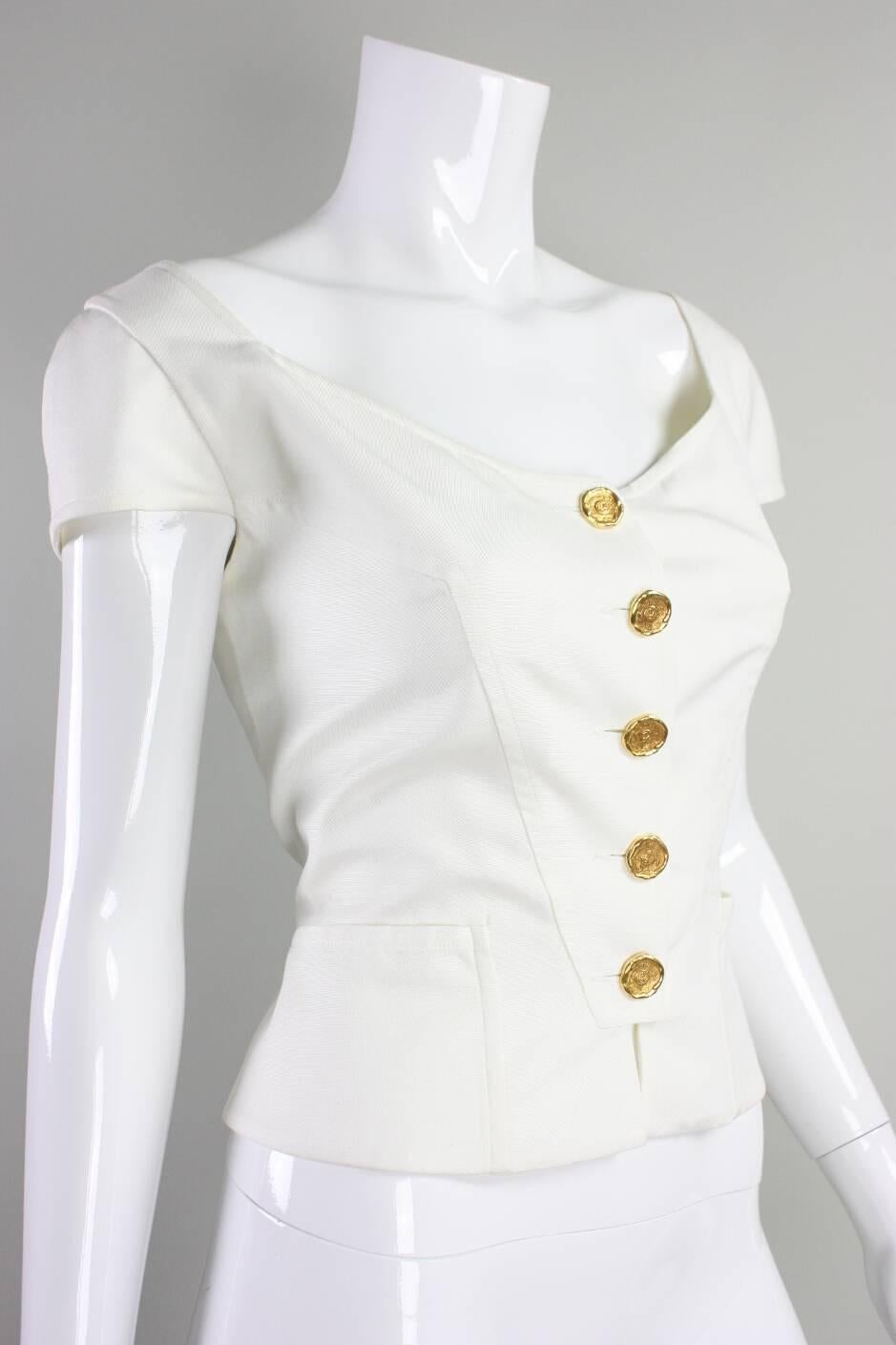 Vintage bodice from Christian Lacroix likely dates to the 1990's.  Scoop neck. Cap sleeves. Center front gold-toned button closure.  Fully lined.

No size label.

Measurements-

Bust: 36"
Waist: 28"
Across Shoulders: 15"
Sleeve