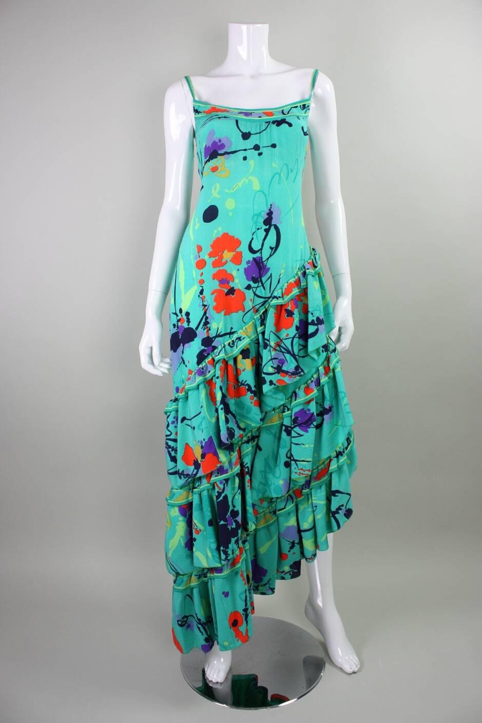 Vintage gown from Leonard of Paris dates to the 1980's and is made of a seafoam green textured silk crepe with an all over active floral and splatter print.  Bodice features scoop front and back neck and narrow straps.  Tiered skirt features three