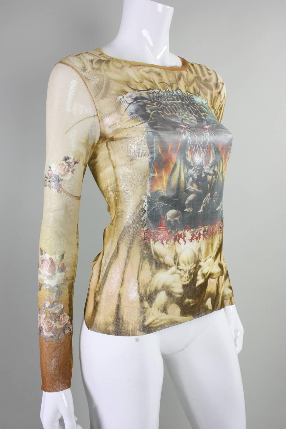 Jean-Paul Gaultier stretch mesh blouse with satanic motif likely dates to the 1990's through 2000's.  Sheer cream-colored netting is printed with demonic imagery and features what appears to be an iron-on transfer at the center front.  Unlined.  No