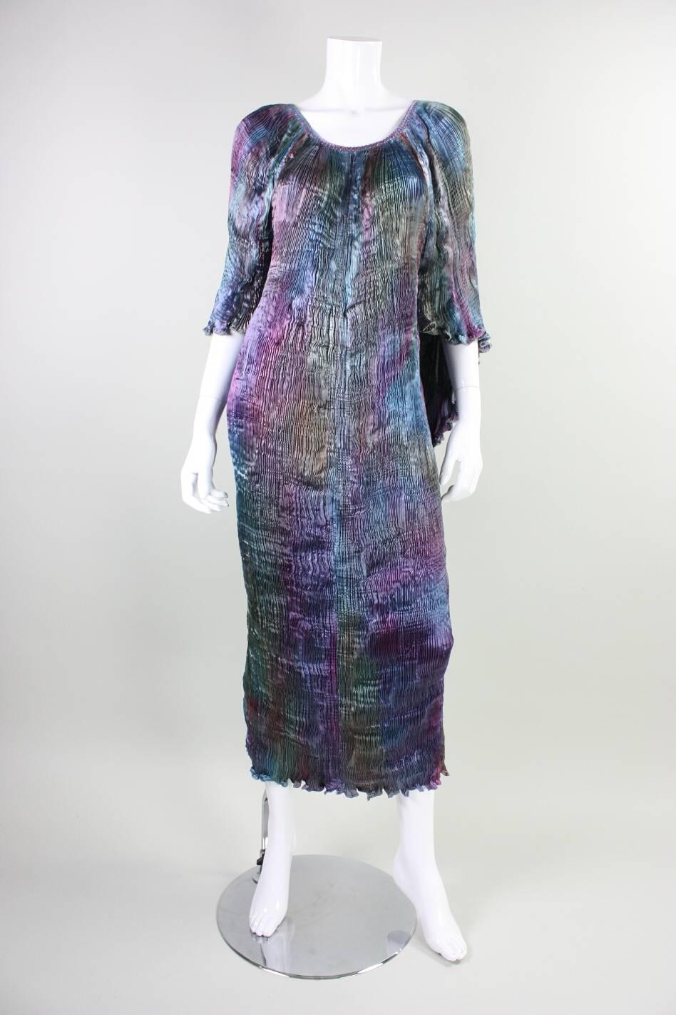 Vintage dress from Patricia Lester likely dates to the 1990's and is made of ombre multicolored pleated silk.  Neckline is trimmed with with spaced silvery blue seed beads.   Same beads are much more tightly spaced on capelet. 
 Unlined.  No