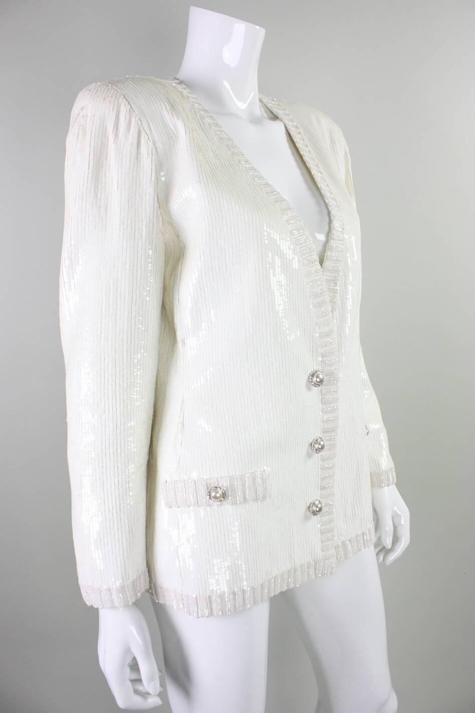 Vintage jacket from Bill Blass dates to the 1980's and features all over white sequins and faux pockets and faux button closures.  This jacket retailed at Amen Wardy.  Three hook and eye closures at center front waist.  Vintage size