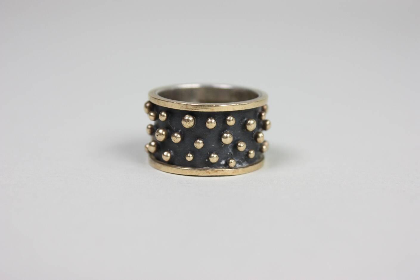 Ring from the late New Orleans designer Anne Pratt is made of sterling silver and 18 karat gold.  It is signed 925 & 18k.

Measurements-
Interior Diameter: 3/4