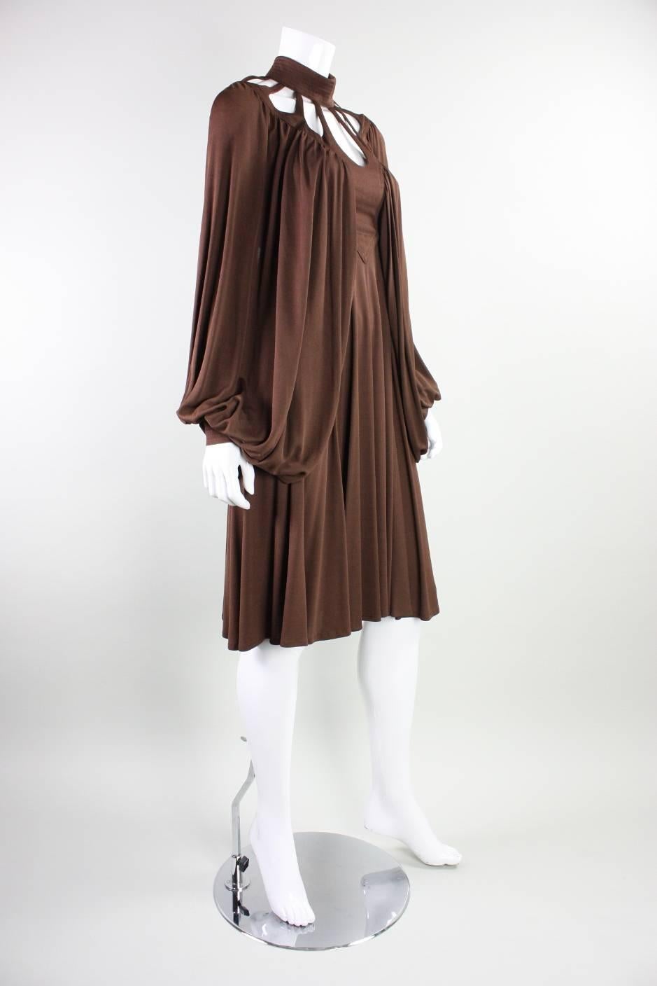 Vintage dress from English designer Leslie Sandra dates to the late 1960's through 1970's.  It is made of high-quality chocolate brown stretch matte jersey and features beautiful rounded cutouts around the front and back necklines.  Dense draping