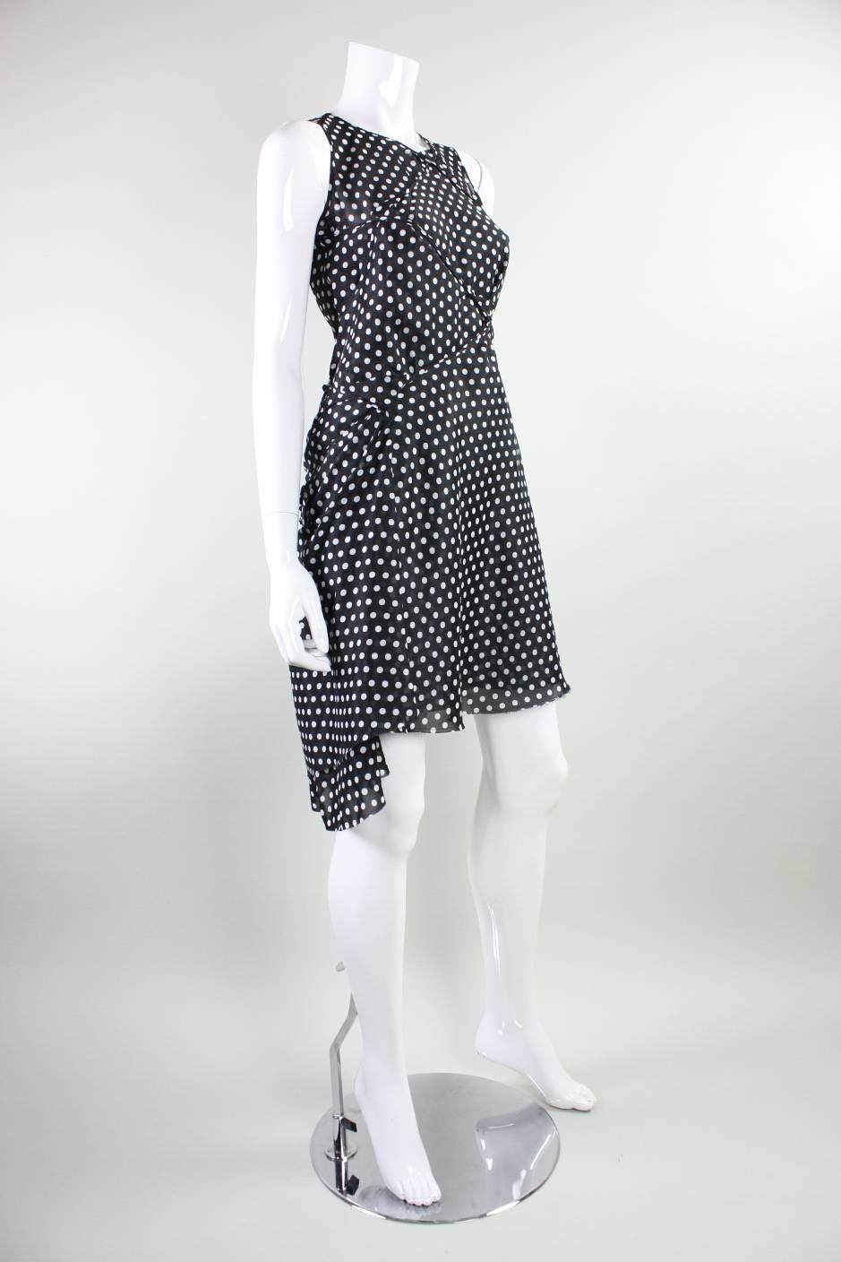 Gorgeous dress by Junya Watanabe for Comme des Garcons dates to 2003 and is made of black dotted chiffon that is manipulated through draping and gathering.  Somewhat lined.  No closures.

Measurements-
Bust: 34