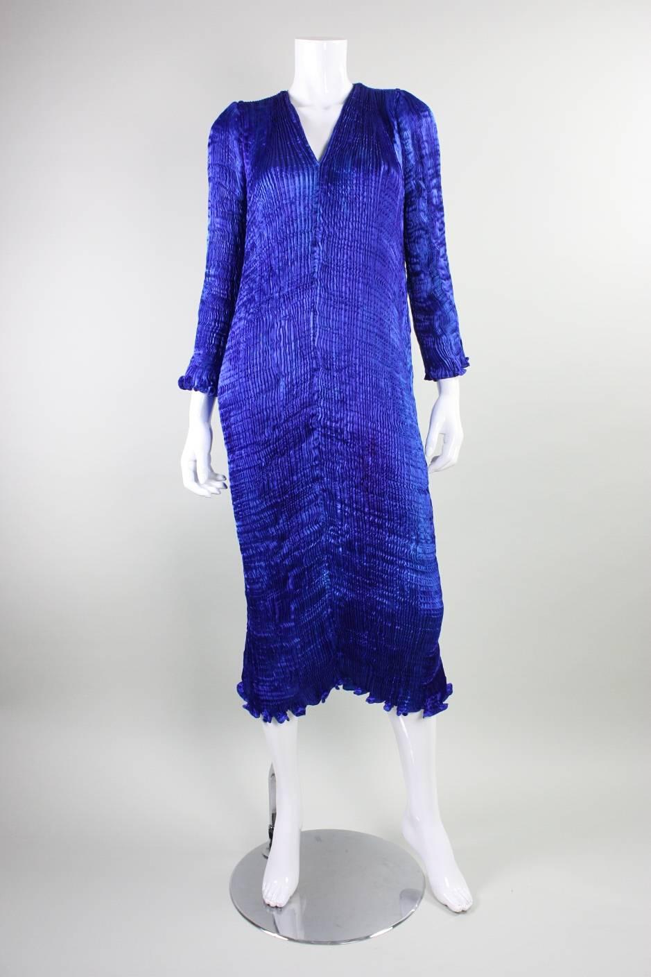 Elegant vintage dress from Patricia Lester likely dates from the 1980's through the 1990's and retailed at Saks Fifth Avenue.  It is made of pleated silk that is hand-dyed in various shades of blue, the most prominent of which is a deep cobalt. 