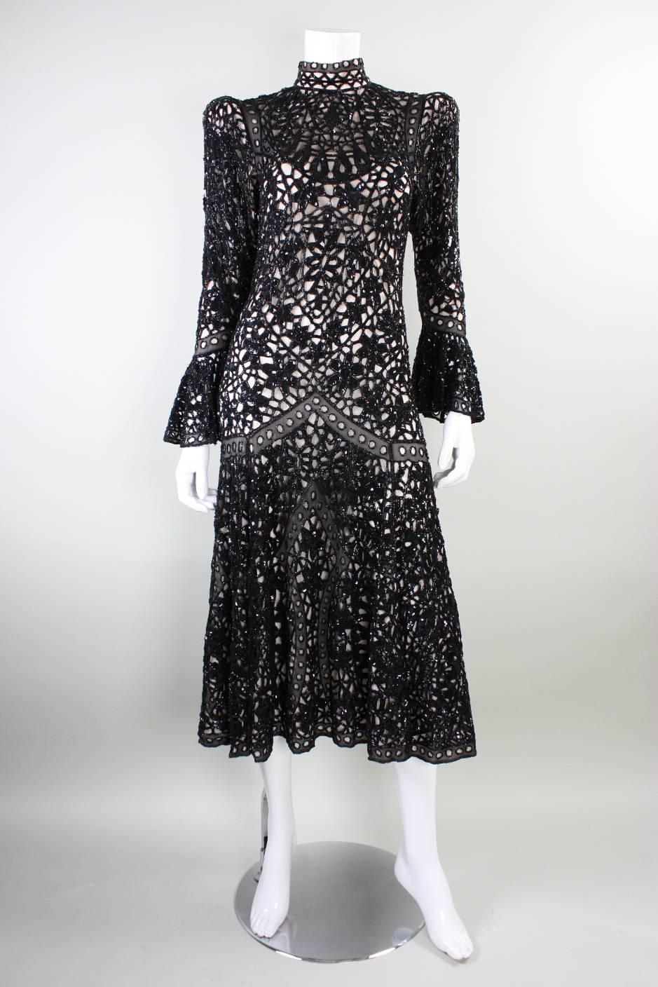 Vintage evening dress from English brand Eavis & Brown dates to the 1980's through 1990's.  It is made of jet black lace that is adorned with black beading and sequins. Nude chiffon lining. Center back looped button closure.  

Labeled a size