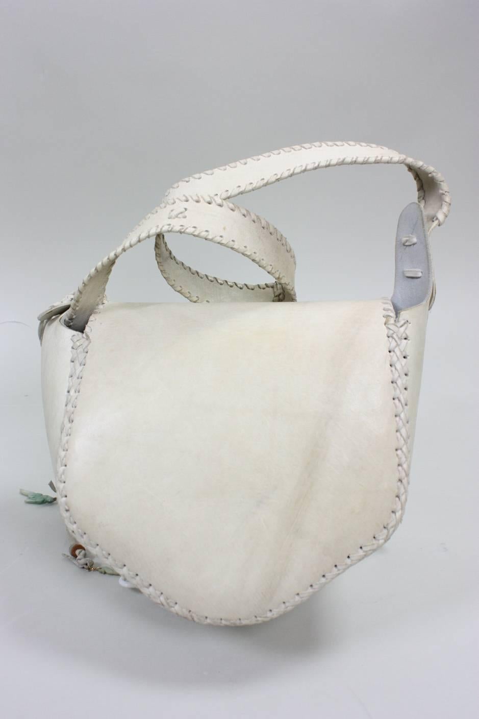 Vintage handbag from Char dates to the 1970's.  It is made of cream-colored leather that features a painted floral motif.  Whipstitched seams and edges.  Flap closure.  Interior side pocket.  Unlined.

Measurements-

Width: 9"
Height: 8