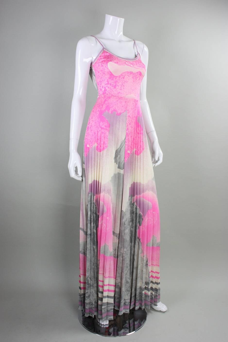 Vintage maxi dress from Leonard Paris dates to the 1970's and is made of matte jersey with an abstracted print in pink and gray.  Fitted bodice has scoop neckline and narrow straps.  Full-length skirt features narrow vertical pleats.  Side zippered