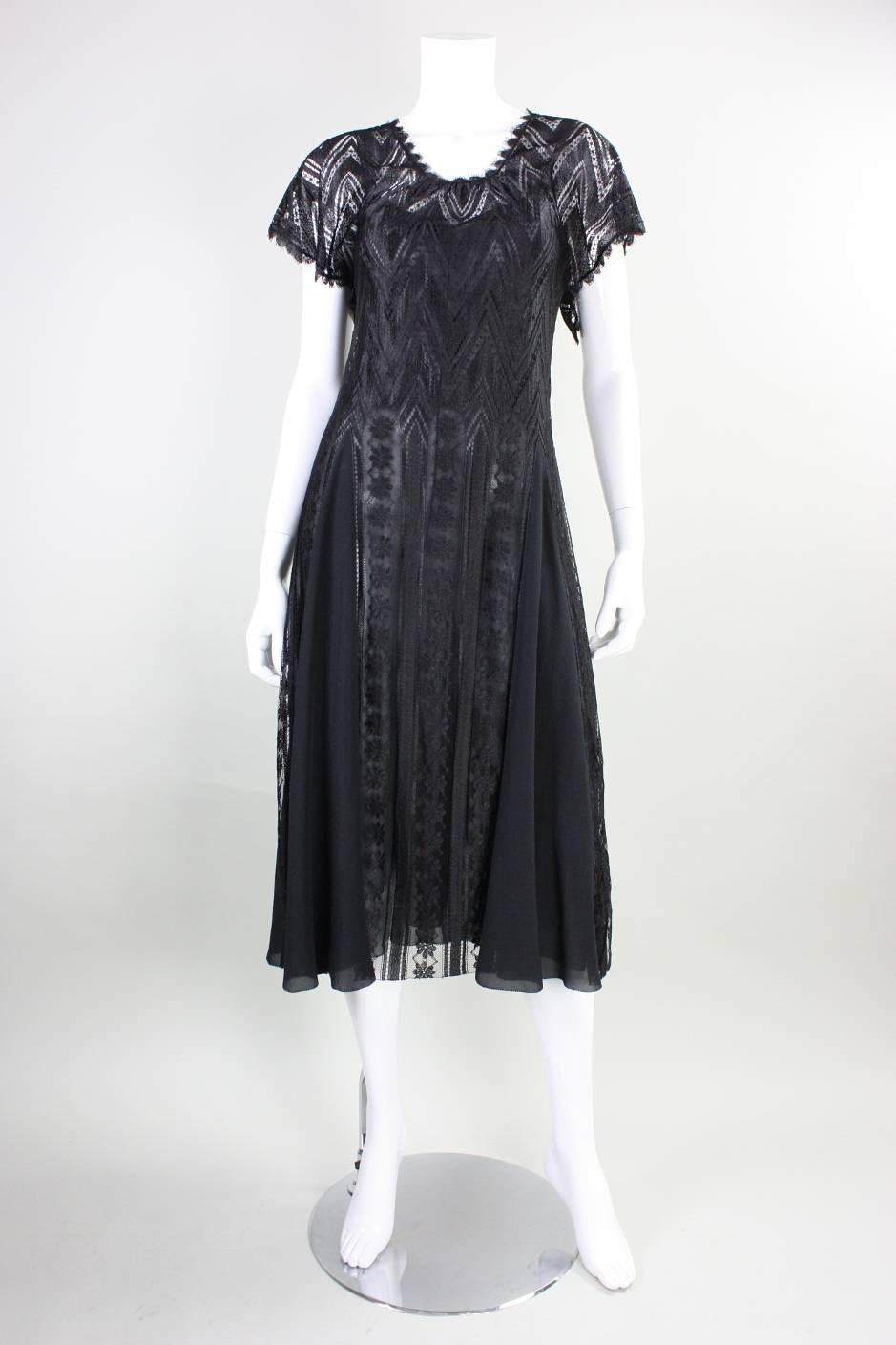 Vintage cocktail dress from Holly's Harp dates to the 1970's through mid-1980's. It is made of floral and geometric patterned lace with silk godets in the skirt.  Rounded scoop neckline is gathered all around.  No closures.  Matching bias-cut black