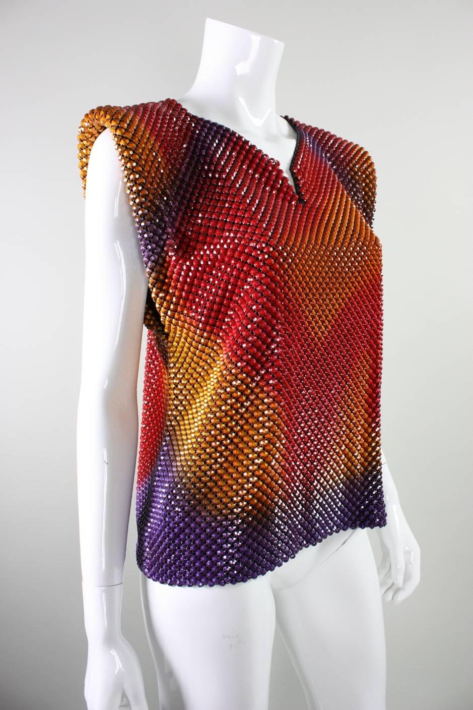 Vintage blouse from Anthony Ferrara dates to the 1980's and is made of three-dimensional metal mesh.  Mesh appears to be airbrushed in a multitude of colors ranging from red to orange to yellow to purple.  Fully lined.  No closures.

Labeled a size
