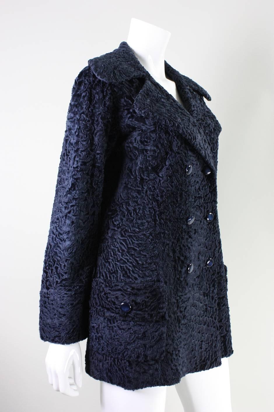 Vintage coat from Edwards-Lowell dates to the 1970's and is made of navy broadtail fur.  It features a wide collar with notch lapel and is double-breasted.  Button closures.  Fully lined.  Hip pockets.

No size label.

Measurements-
Bust: 38