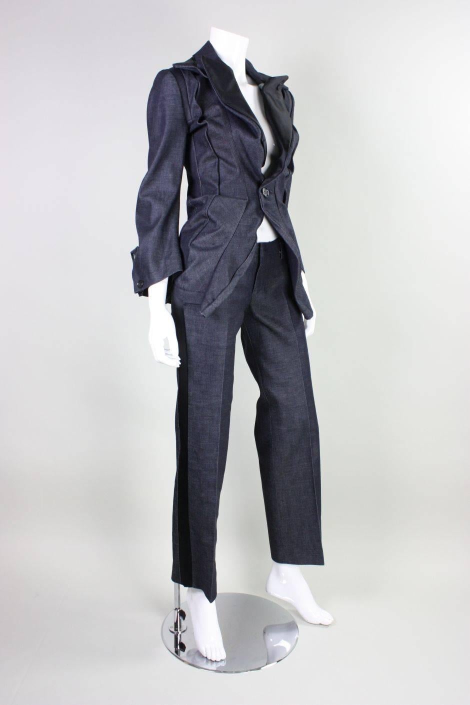 Contemporary ensemble from Junya Watanabe for Comme des Garcons dates to 2006 and is made of dark blue cotton denim with black polyester/silk blend trim.  Jacket is single breasted and has one button closure at the waist.  Sleeves have openings at