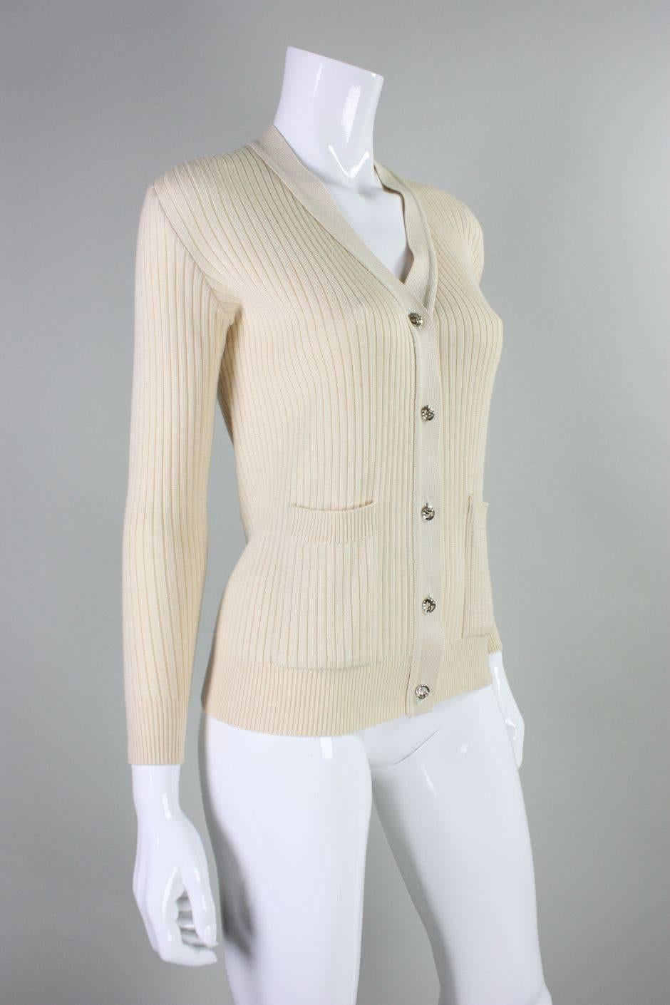 Vintage cardigan from Hermes dates to the 1970s and is made of a beige cashmere/silk blend.  Two patch pockets at waist.  Center front 5 button closure.  Ribbed trim around neckline, cuffs, and waist.  Labeled vintage size 40.
Measurements
Bust: