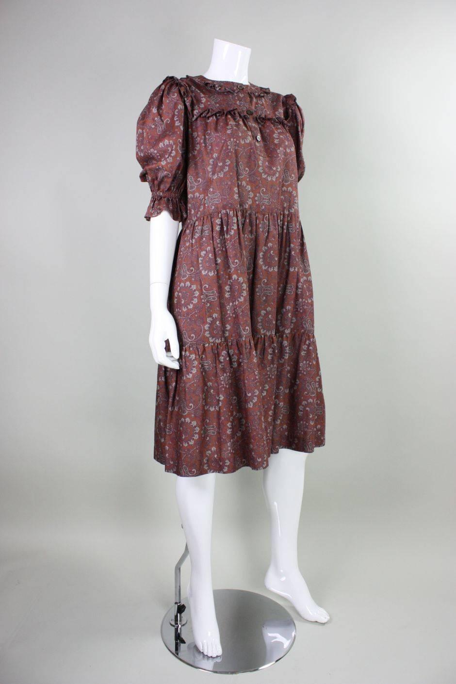 Vintage dress from Yves Saint Laurent Rive Gauche label dates to the early to mid-1980's and is made of rust orange cotton with a paisley pattern.  Center front button closure.  Unlined. Labeled size 34.  
Please note that even though the bust