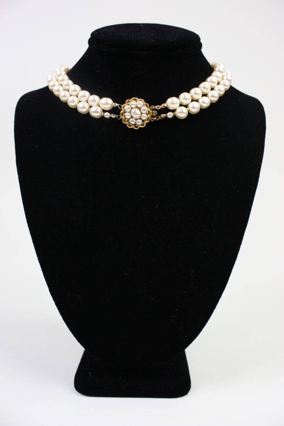 Vintage necklace from Miriam Haskell dates to the 1950's through 1960's and is comprised of a double strand of cream-colored baroque pearls with a cluster of large baroque pearls at the center neck.  Rhinestones of various colors and sizes are