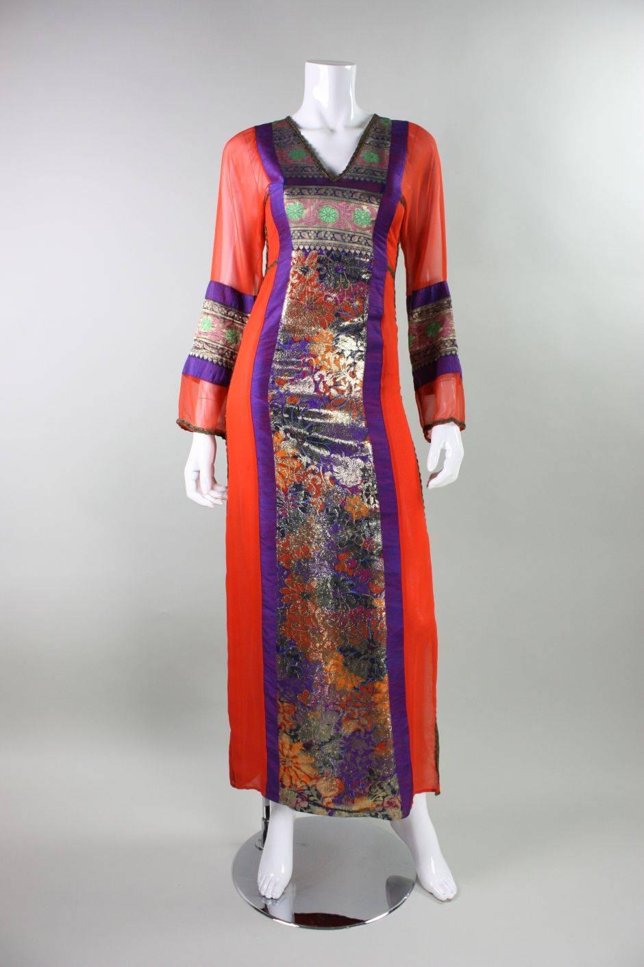 Vintage gown from English designer Thea Porter dates to the 1970's and retailed at Giorgio Beverly Hills.  It is made of a variety of fabrics including an orange silk chiffon, purple/blue silk shantung, and ethnic metallic jacquard.  V-neck and