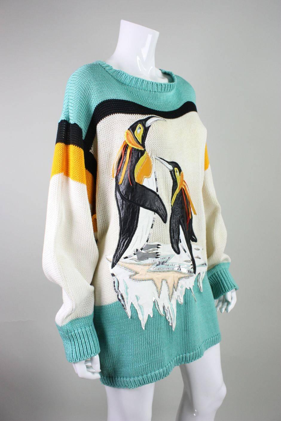 Fun vintage sweater by Szato dates to the 1980's and is made of black, cream, yellow, and turquoise cotton yarn.  The front features large penguins that are artfully appliqued with leather.  Unlined.  No closures. 
Labeled a size Medium, but would