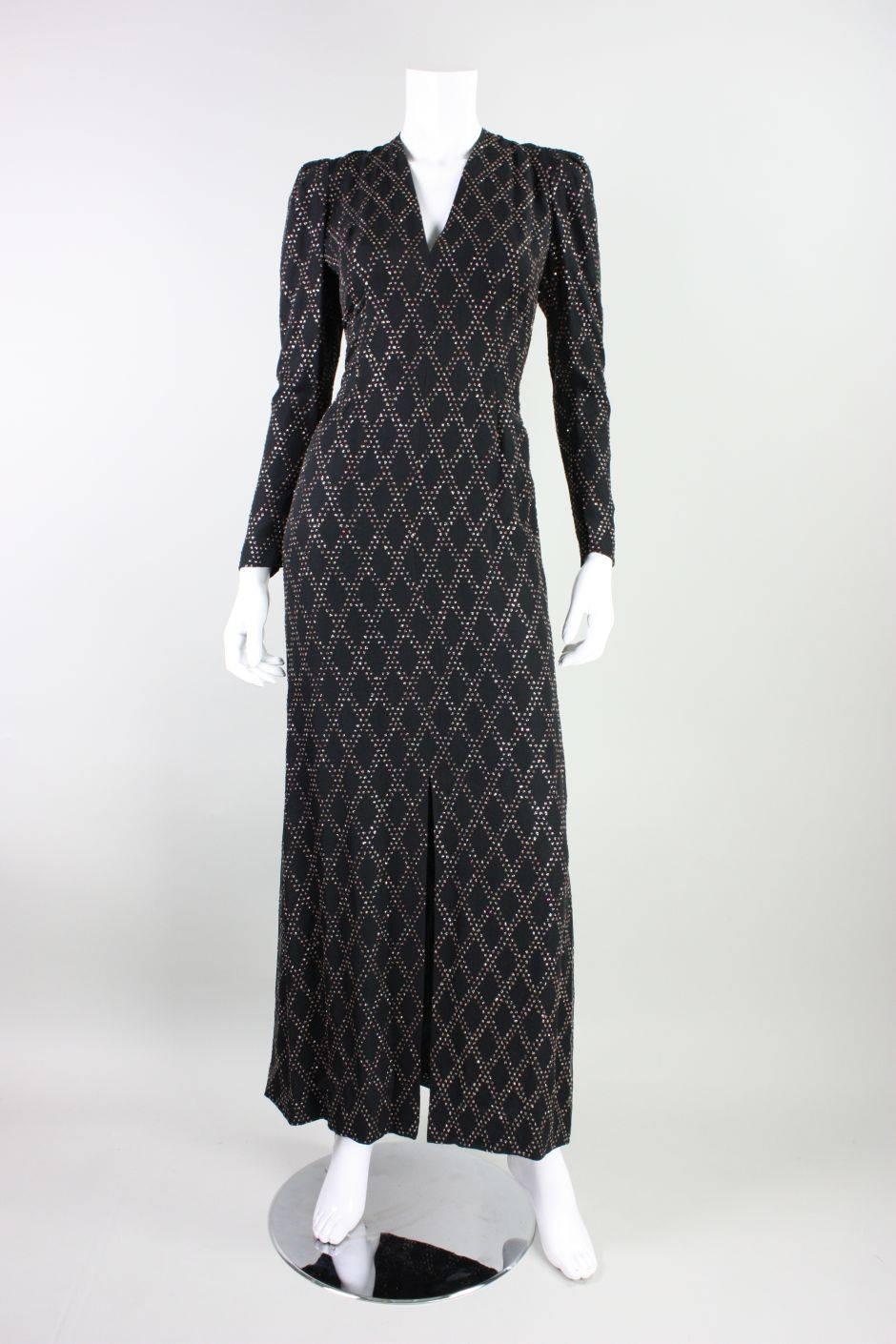 Vintage custom-made gown dates to the 1970's and is made of black silk chiffon with silver & pink glitter glued on in a diamond pattern. Slit v-neck.  Long sleeves with double snap cuff have pintucking along armhole, which results in light volume in