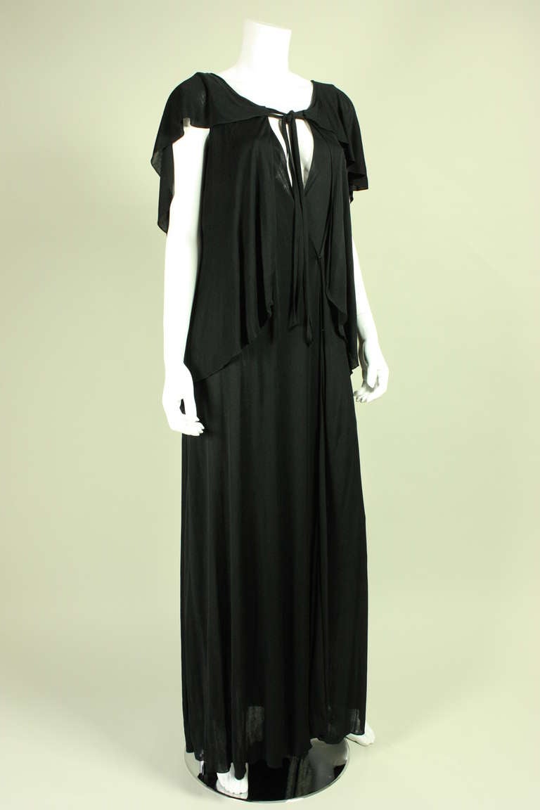 Vintage gown from Holly's Harp dates to the 1970's and is made of tiered black matte jersey.  Keyhole neckline.  Optional detached belt (not shown).  Hook and eye closures.

No size label.

Measurements-

Bust: 34-36