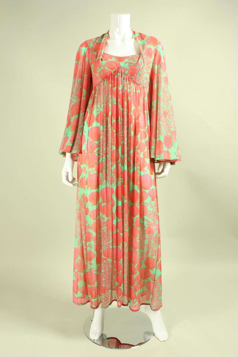 Vintage dress from Robert-David Morton dates to the 1970's and is made of a synthetic jersey with an allover seashell print in pink and light green.  Unique sweetheart-like neckline has fullness at the bust that is created through gathers at the