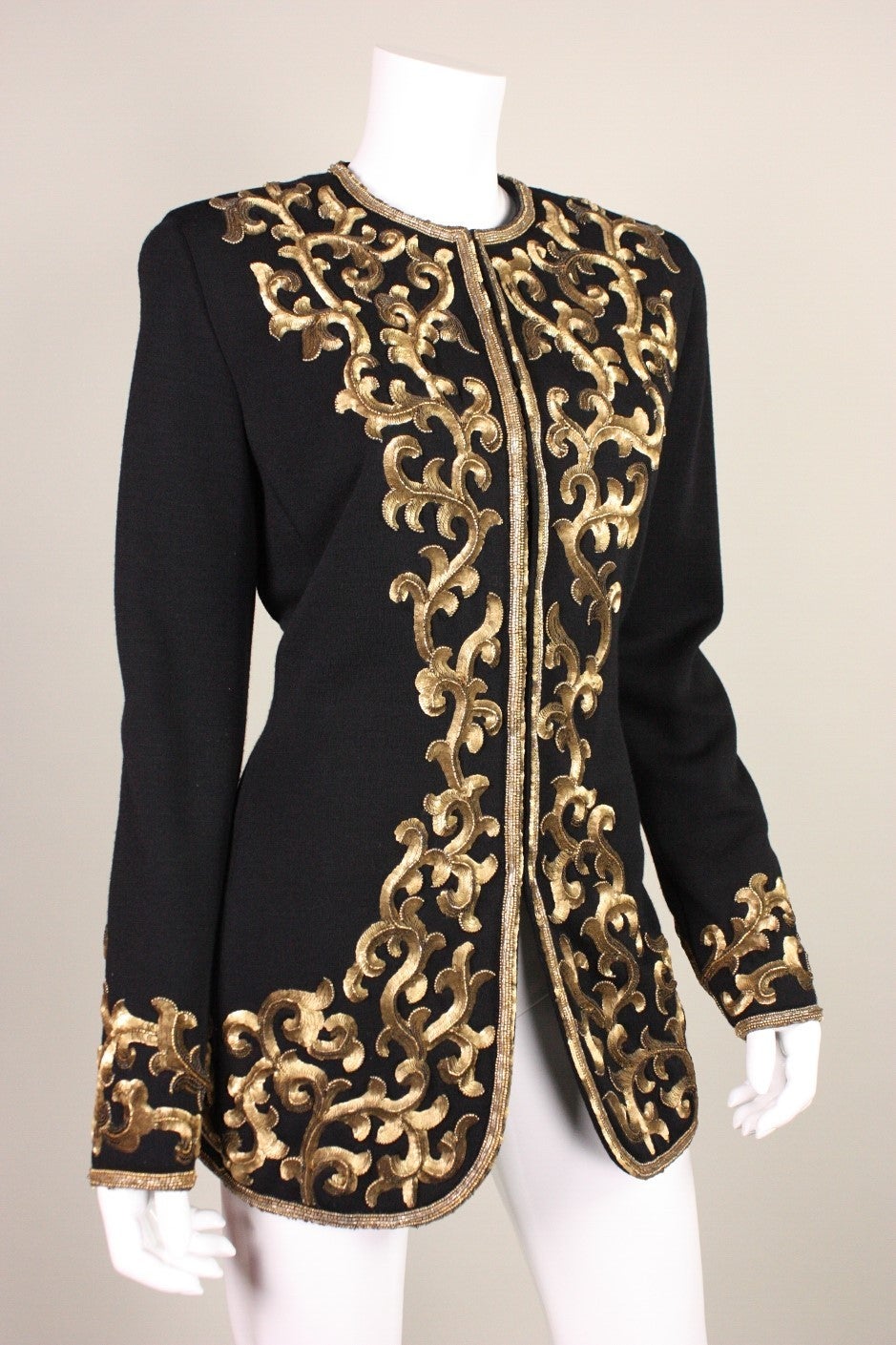 Donna Karan Black Jacket with Gold Sequined Embellishment.  Lined.  Center front hook and eye closures.

Fits approximately a size 6-8.