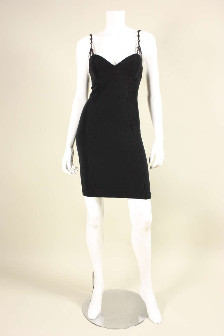 Vintage dress from Gianni Versace dates to the 1990's and is made of stretchy black synthetic faille.  Leather straps have gunmetal gray metal Medusa hardware.  Very bodycon.  Center back zipper.  Unlined.