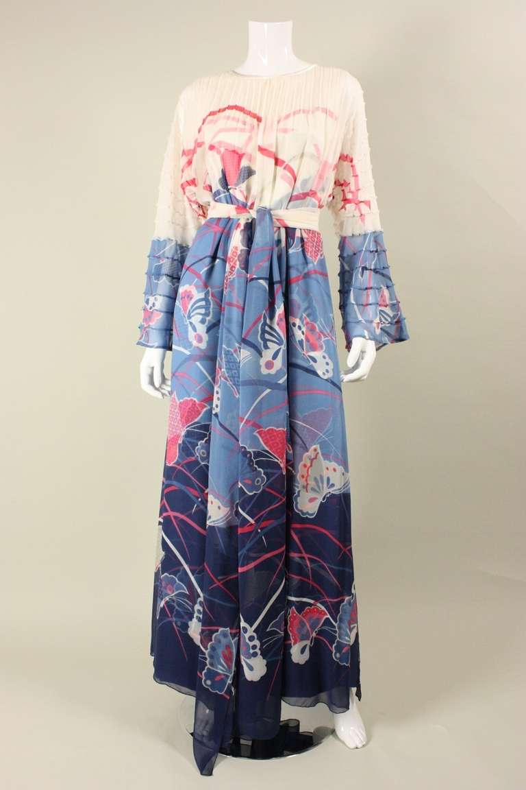 Vintage gown from Hanae Mori's Couture line dates to the 1970's.  It is made of a fitted silk underlayer with a loose-fitting silk chiffon overlay with a center front opening.  Overlayer has pintucks throughout upper bodice and down sleeves. 