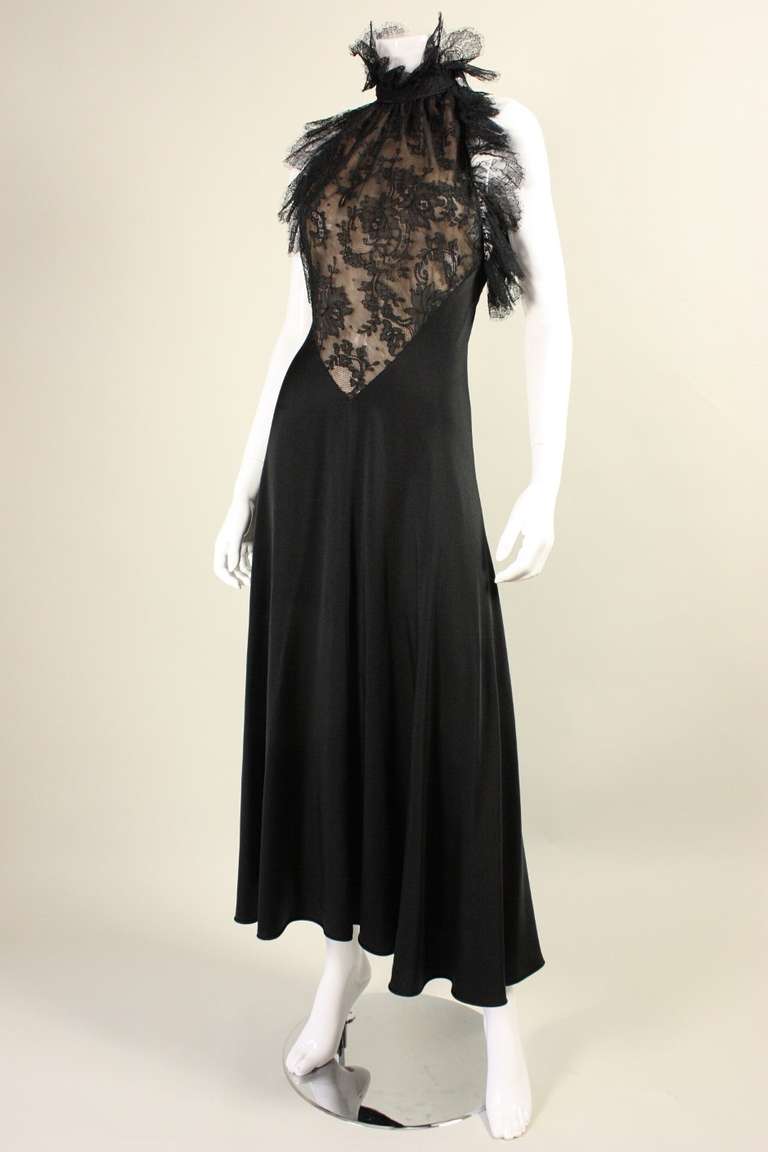 Smashing evening dress is made of black silk with black floral lace inserts.  Armholes and neckline are both trimmed with gathered black lace.  Side neck hook and eye closure.  Lace inserts are lined with nude fabric, but skirt is not lined.  There