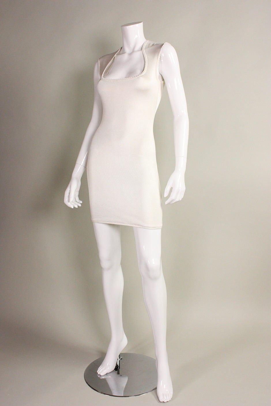 1990's Alaia dress is made of his signature body-con jersey in white.  Scoop neck with picot trim.  Center back invisible zipper.  Unlined except for in bust.

Labeled size Small, but would likely accommodate an Extra Small as well.