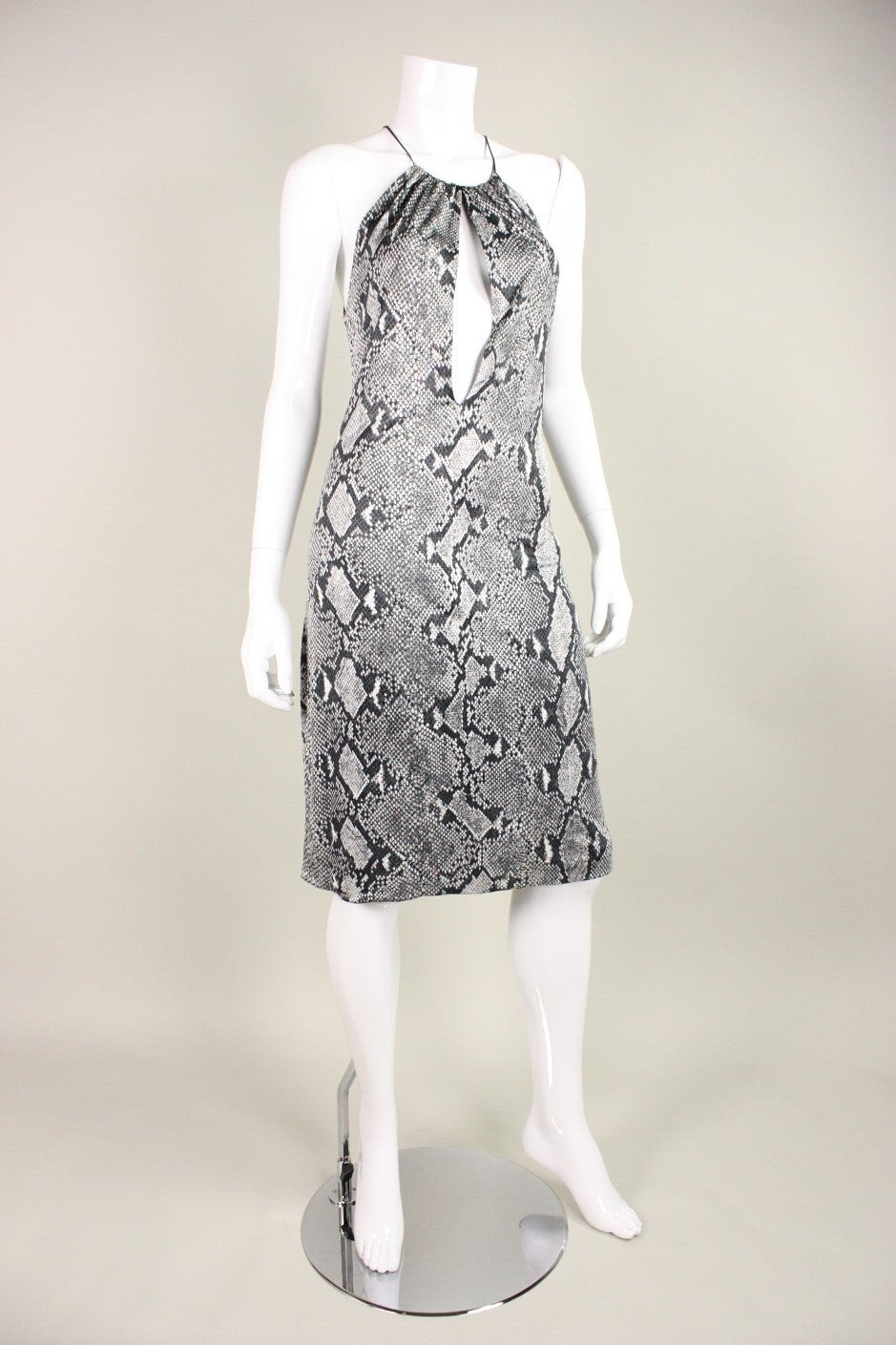 Sexy dress by Tom Ford For Gucci is made of two layers of silk jersey with a monochromatic snakeskin print.  Large keyhole in center front extends from the neckline to navel. No closures. Dress dates to Gucci's S/S 2000 collection.

Labeled a size
