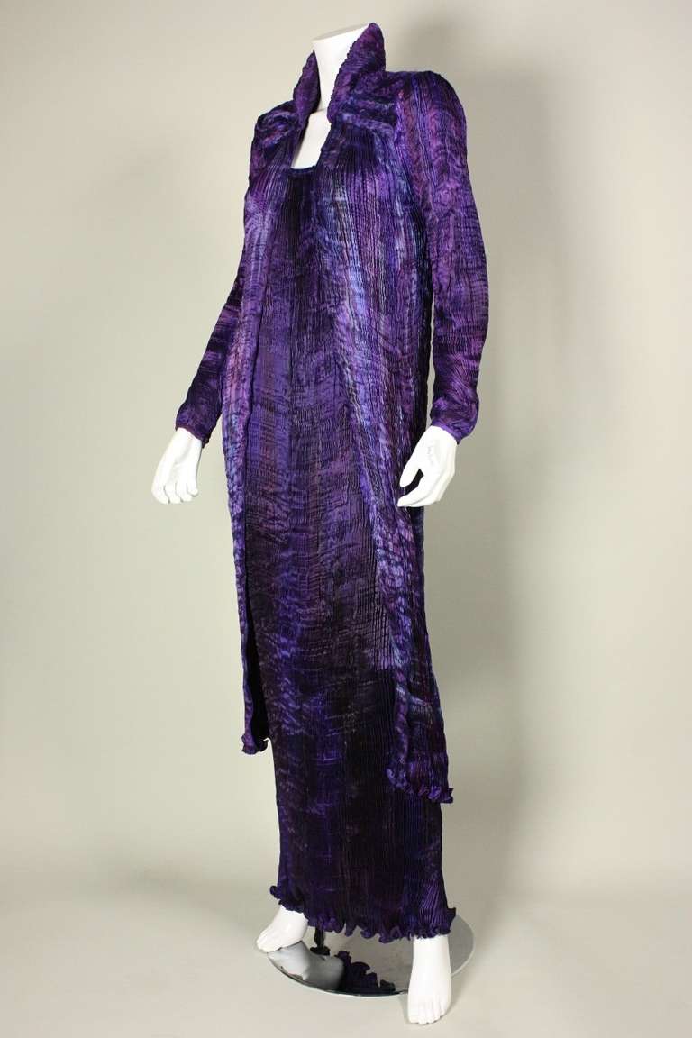 Patricia & Charles Lester pleated ensemble is made of dyed and printed pleated silk.  Dress has scoop front and back neck with beading around neckline.  Coat has smocking at front and back yoke.  Both pieces are unlined and have no closures.  Never