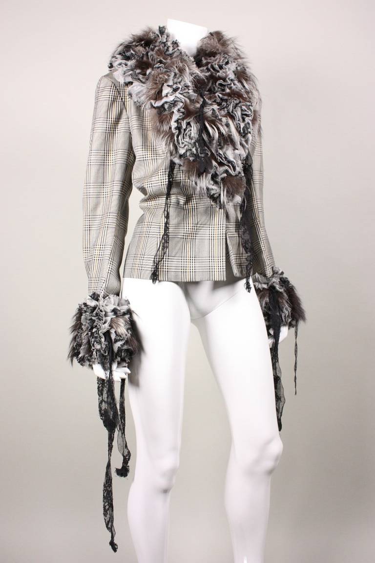 John Galliano jacket is made of wool gabardine in a black and white houndstooth pattern.  Three-dimensional collar and cuffs are comprised of fur and ruffles.  Single breasted with single button closure at waist.  Back vent.  Fully lined.

No size