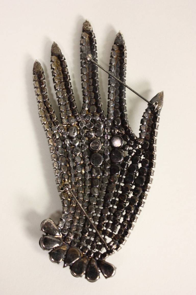 Extra large brooch from Butler & Wilson likely dates to the 1980's.  It is made of silver-toned metal with black and clear faceted rhinestones.  

Measurements-
Length: 5 3/4