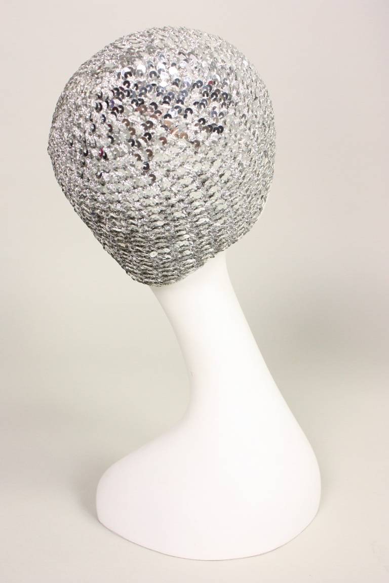 Vintage skull cap from Halston retailed at Saks Fifth Avenue and dates to the 1970's.  It is made of silver knit that is entirely covered in silver sequins.  No closures.  Unlined.